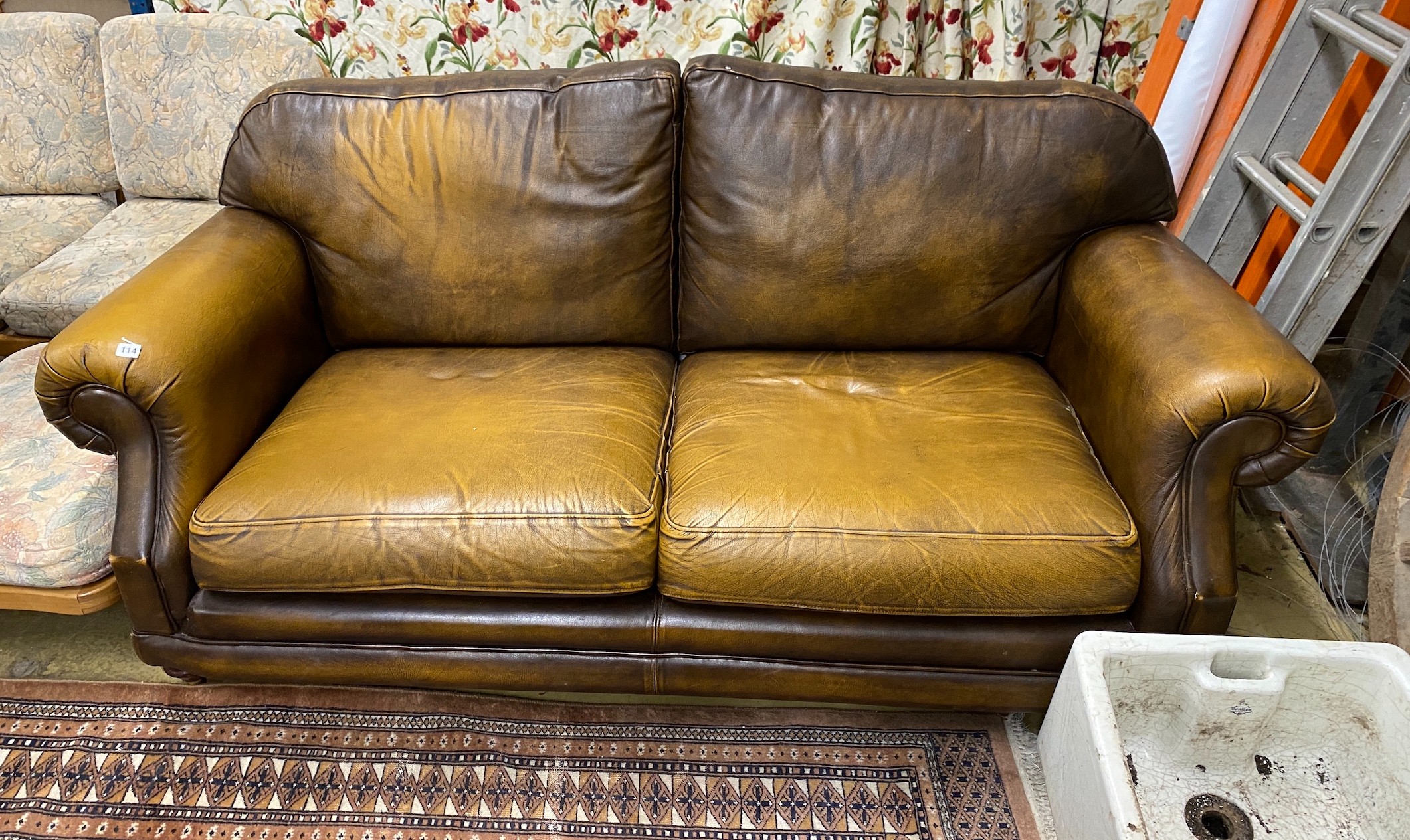 A Thomas Lloyd tan leather two seater sofa, length 190cm, depth 95cm, height 86cm